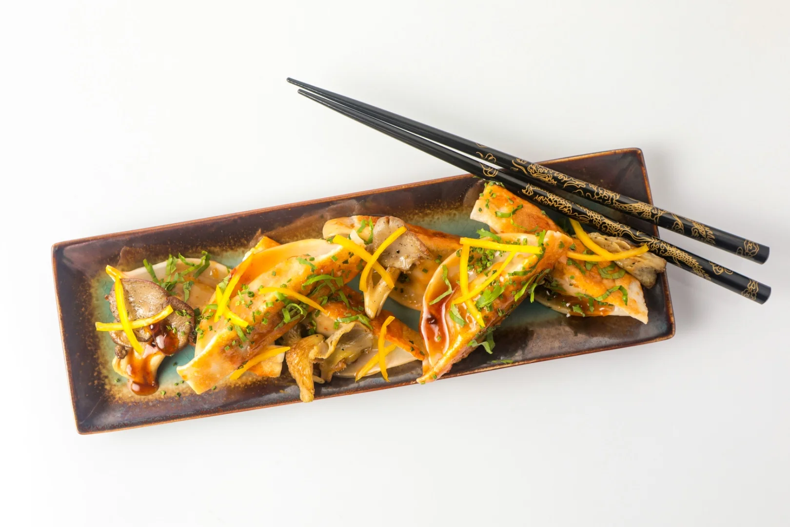 Vegan dumplings with black chopsticks